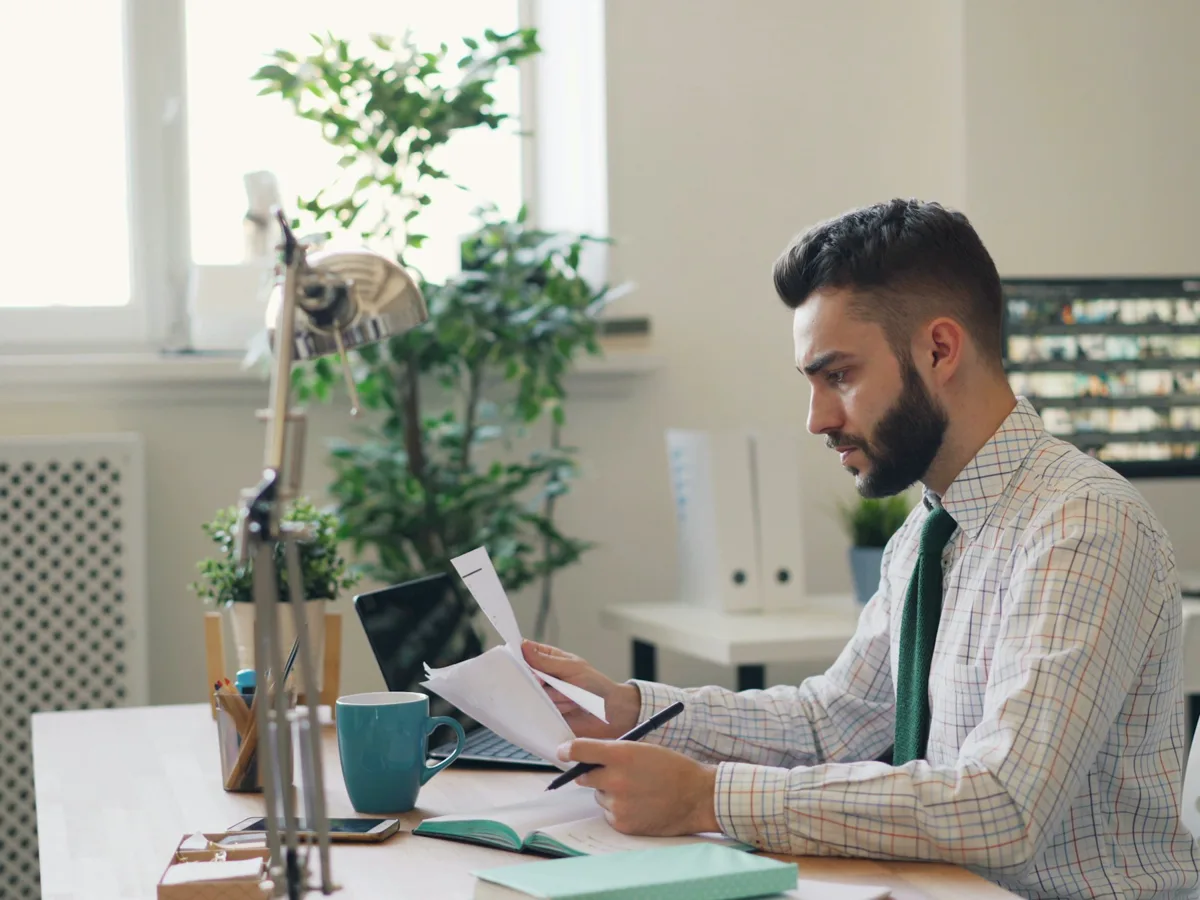 A title professional reading through a file at a desk